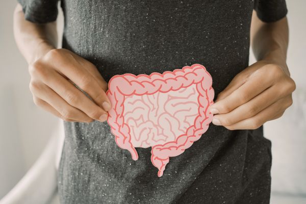 A man holding a picture of an intestine signifying his healthy gut.
