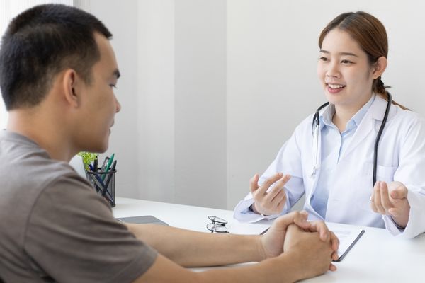 Man consulting doctor before taking probiotics