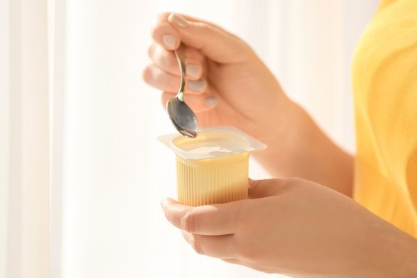 Woman enjoying a cup of yogurt